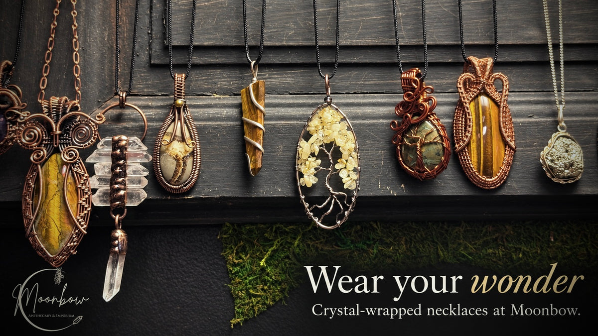 Crystal-wrapped necklaces displayed at Moonbow with the words Wear your wonder